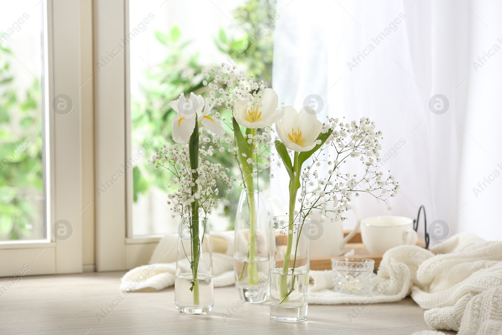 Photo of Beautiful fresh flowers on window sill indoors