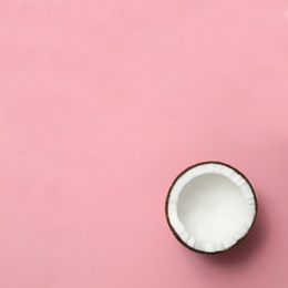 Photo of Fresh coconut half on pink background, top view. Space for text