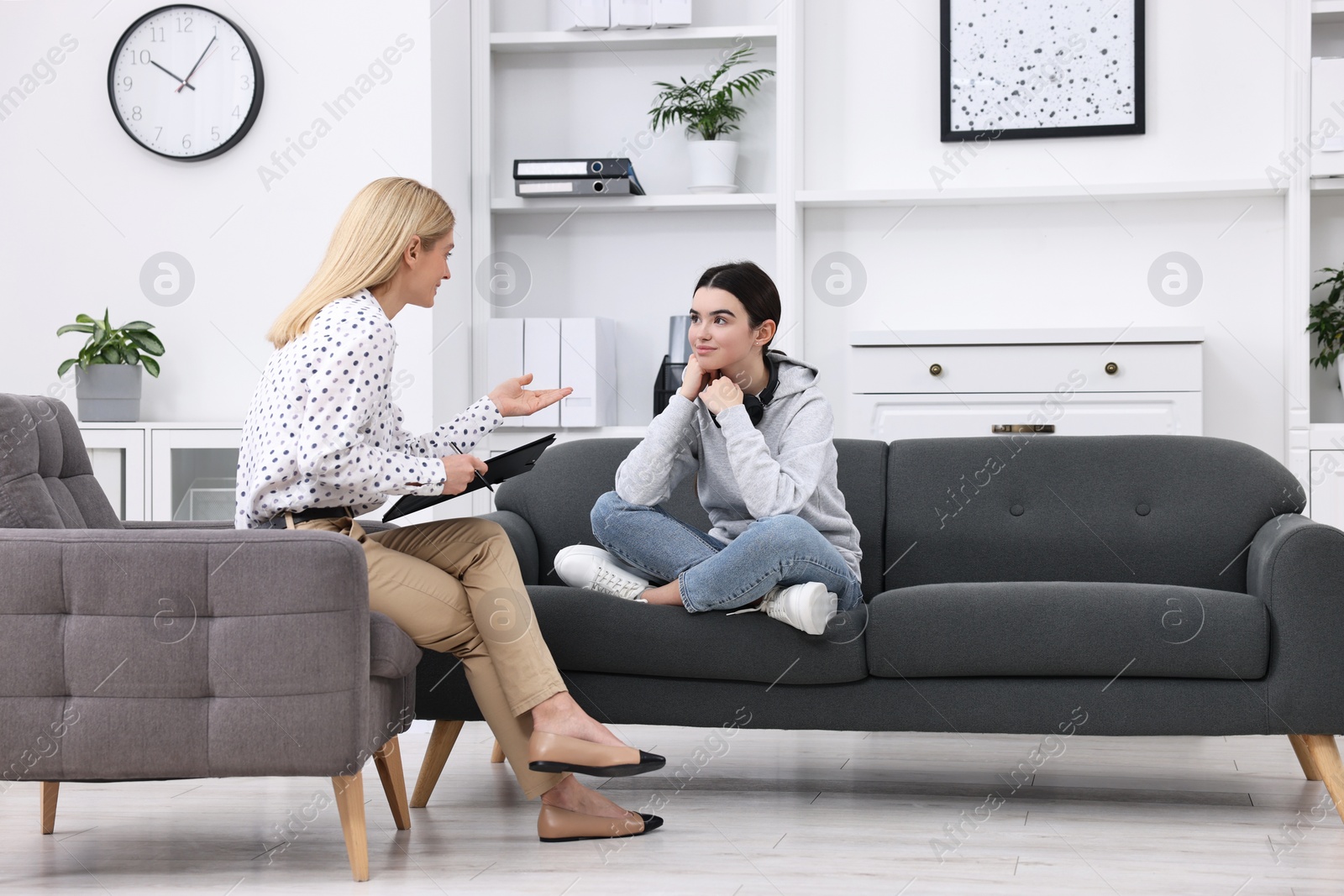 Photo of Psychologist working with teenage girl in office