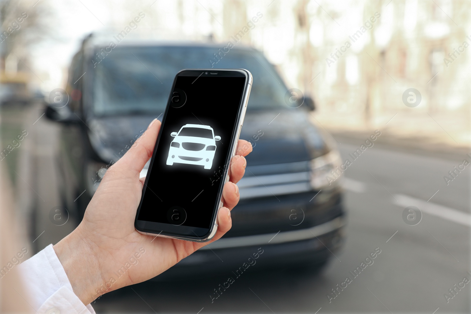 Image of Woman using phone for car insurance outdoors, closeup