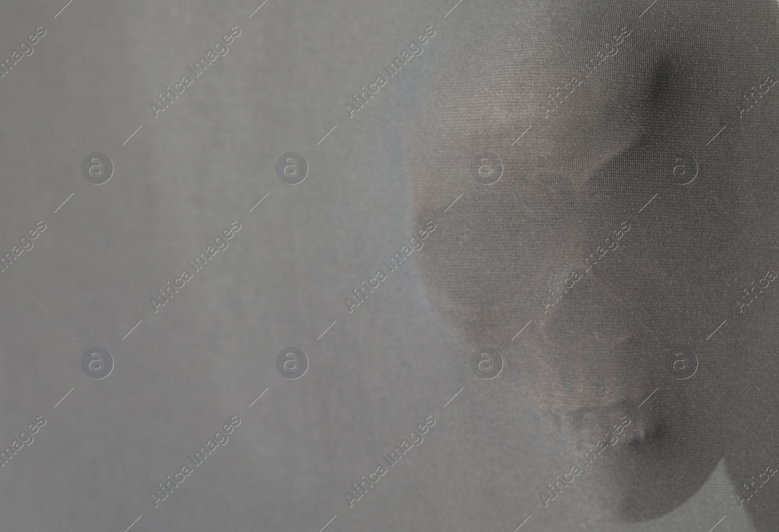 Photo of Silhouette of creepy ghost with skull behind cloth, space for text