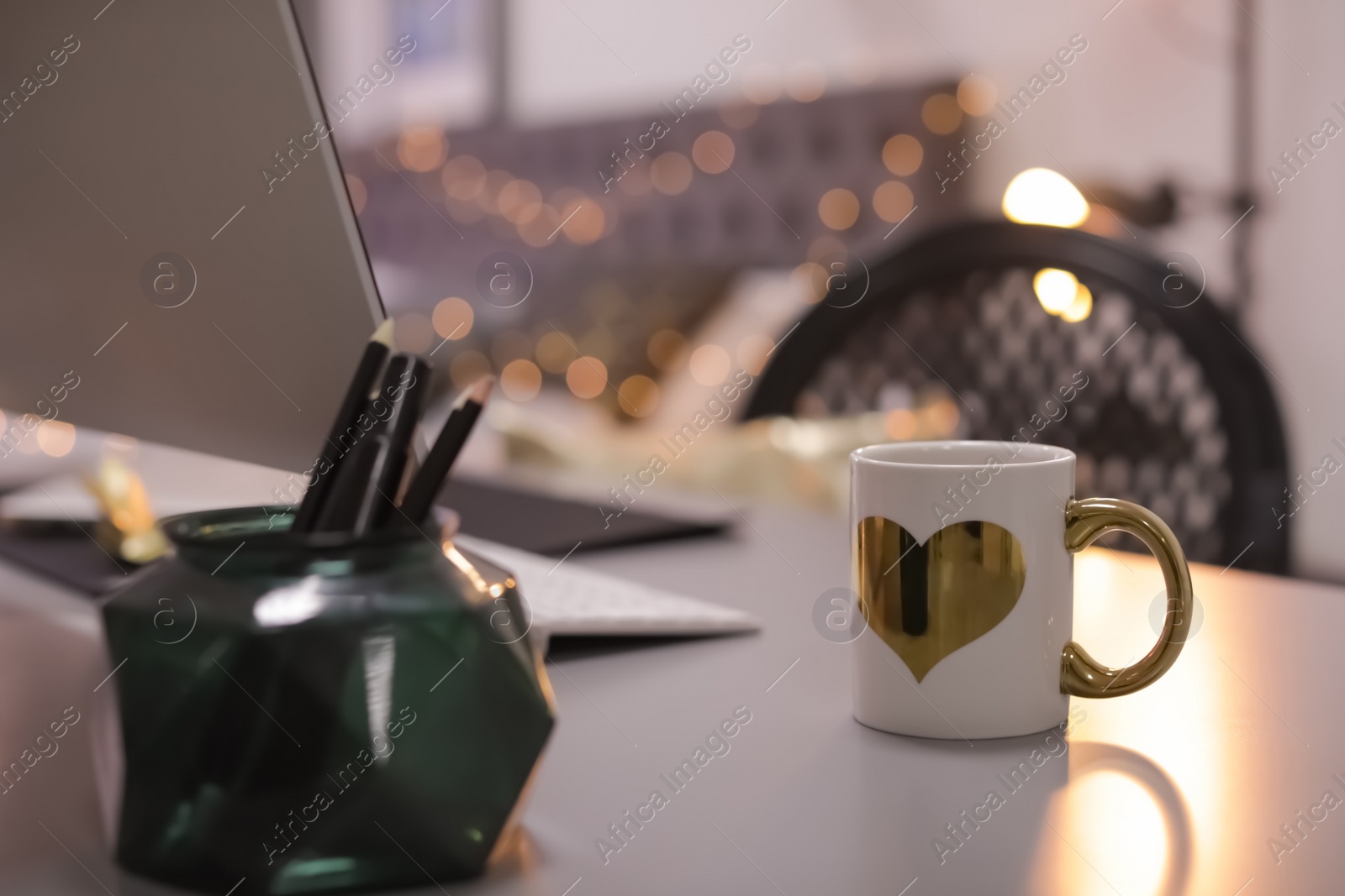 Photo of Stylish workplace with modern computer on desk. Focus on cup of drink