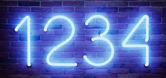 Image of Glowing neon number (1, 2, 3, 4) signs on brick wall