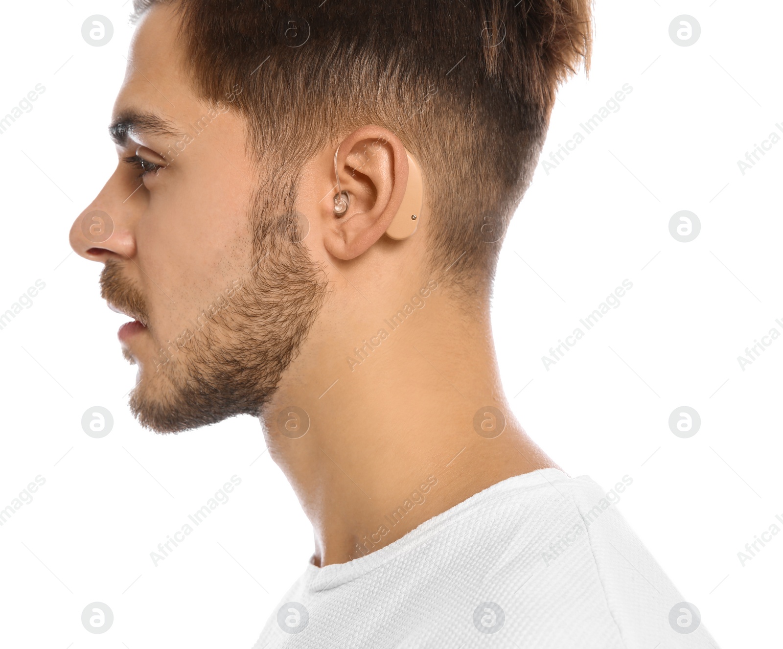 Photo of Young man with hearing aid on white background