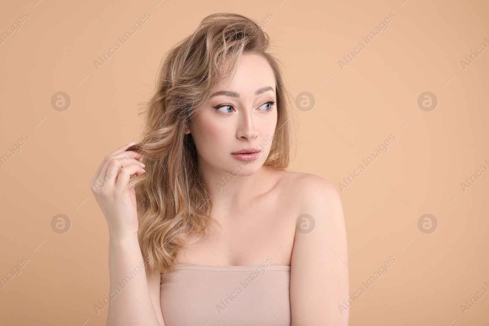 Photo of Portrait of beautiful woman on beige background