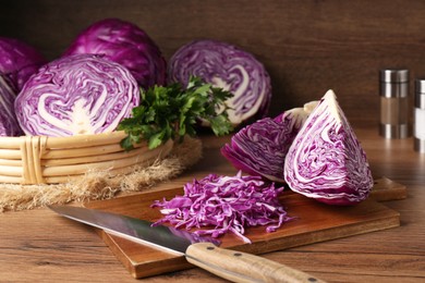 Photo of Fresh red cabbage shredded on wooden table