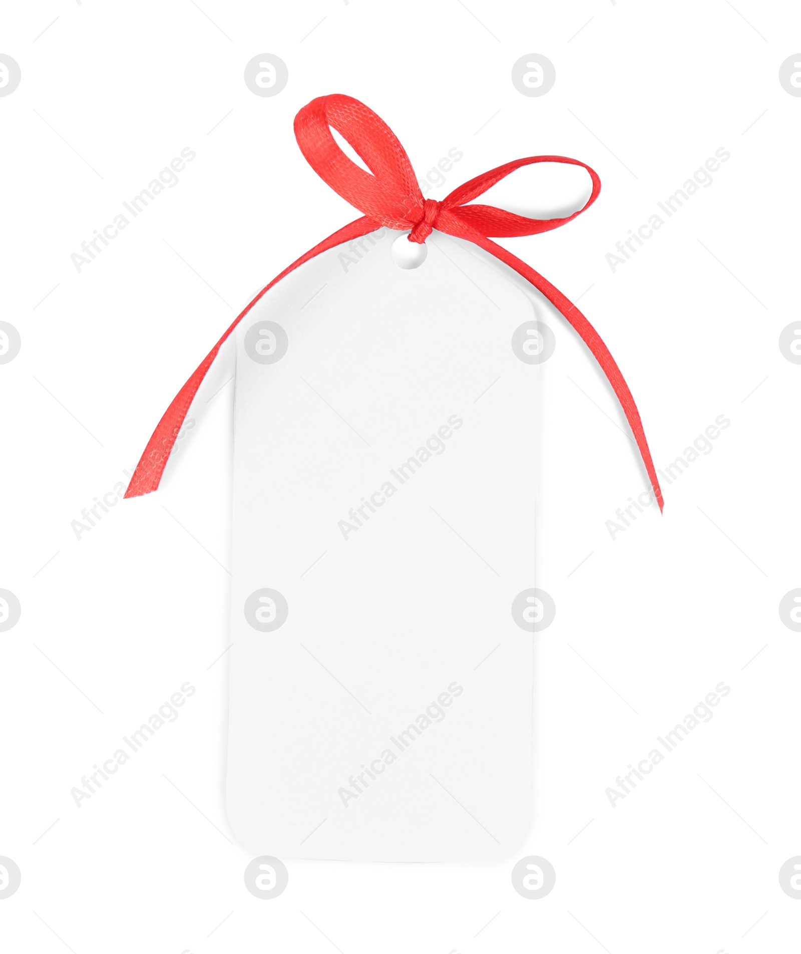 Photo of Blank gift tag with red satin ribbon on white background, top view