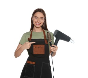 Photo of Portrait of happy hairdresser with hairdryer and round brush on white background