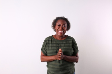 Photo of Portrait of happy African-American woman on white background