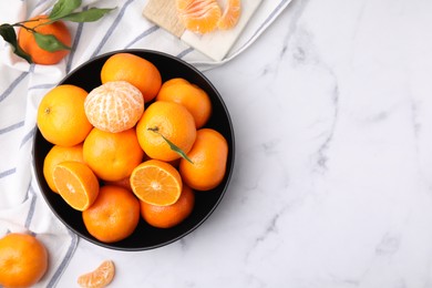 Fresh juicy tangerines on white marble table, flat lay. Space for text