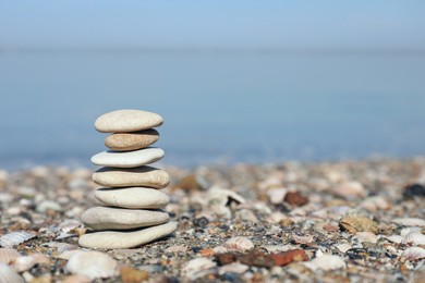 Photo of Stack of stones on beach, space for text. Harmony and balance concept