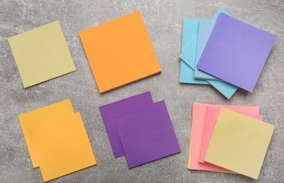 Colorful stickers on light grey stone table, flat lay