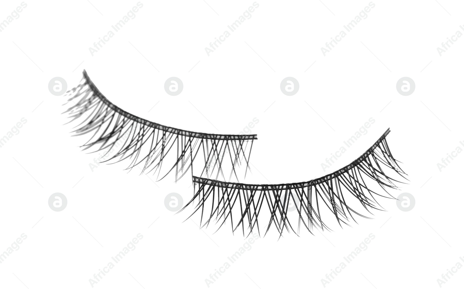 Photo of Fake eyelashes on white background. Makeup product