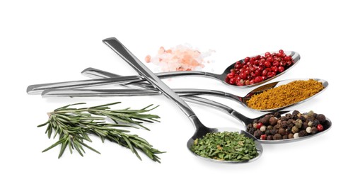 Metal spoons with different spices, salt and rosemary on white background