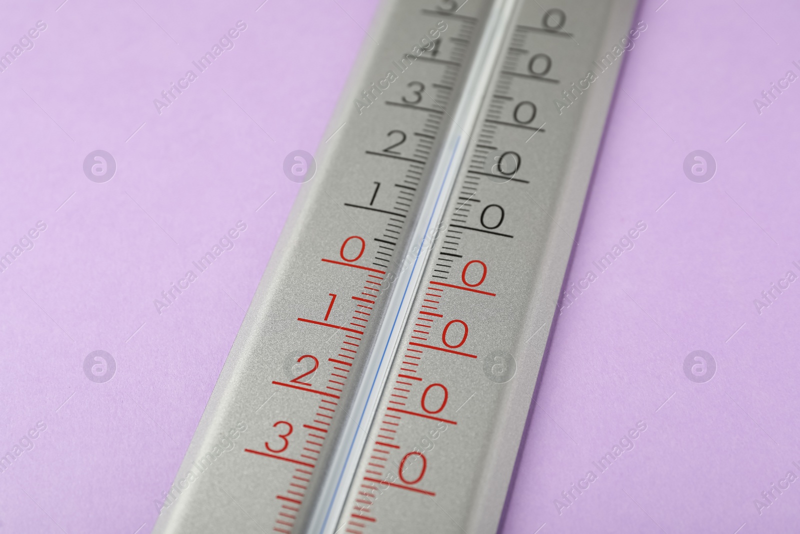 Photo of Modern weather thermometer on lilac background, closeup