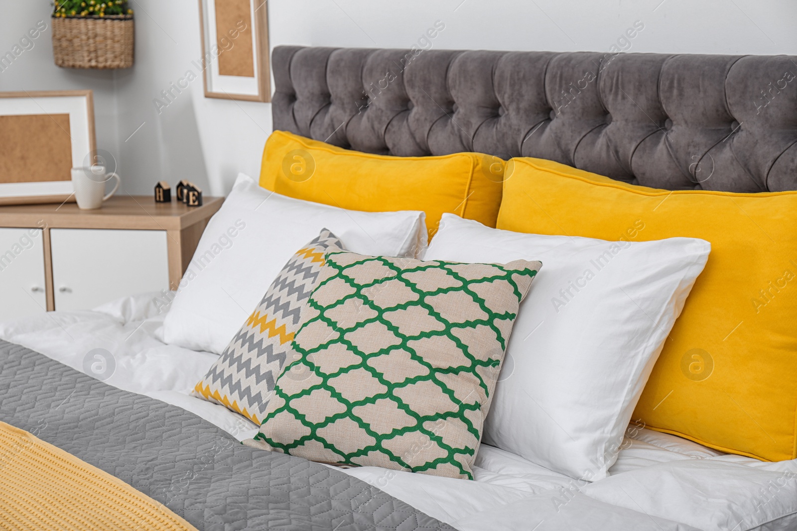 Photo of Big bed with soft pillows in stylish room interior