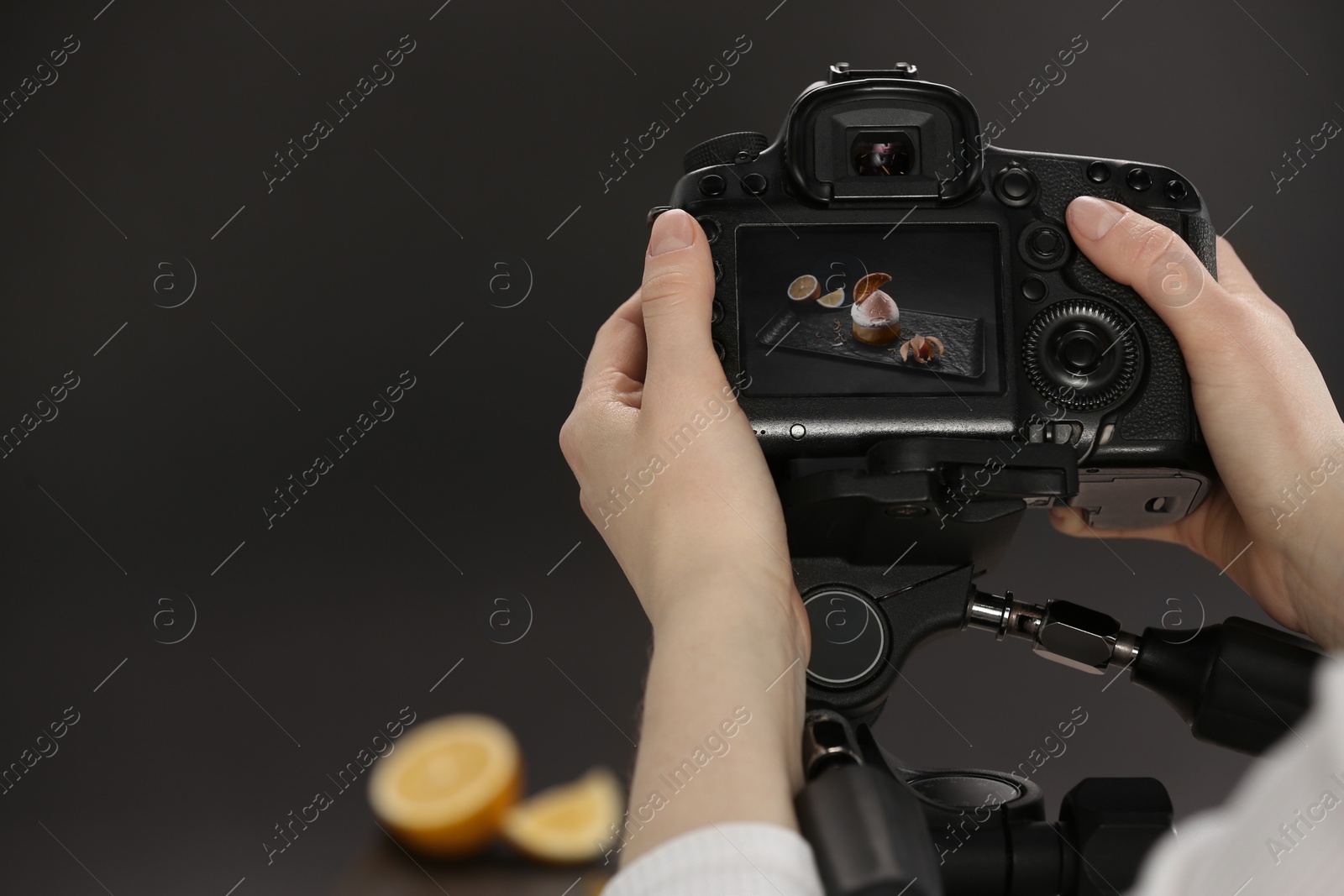 Photo of Food stylist taking photo of delicious dessert in studio, closeup. Space for text