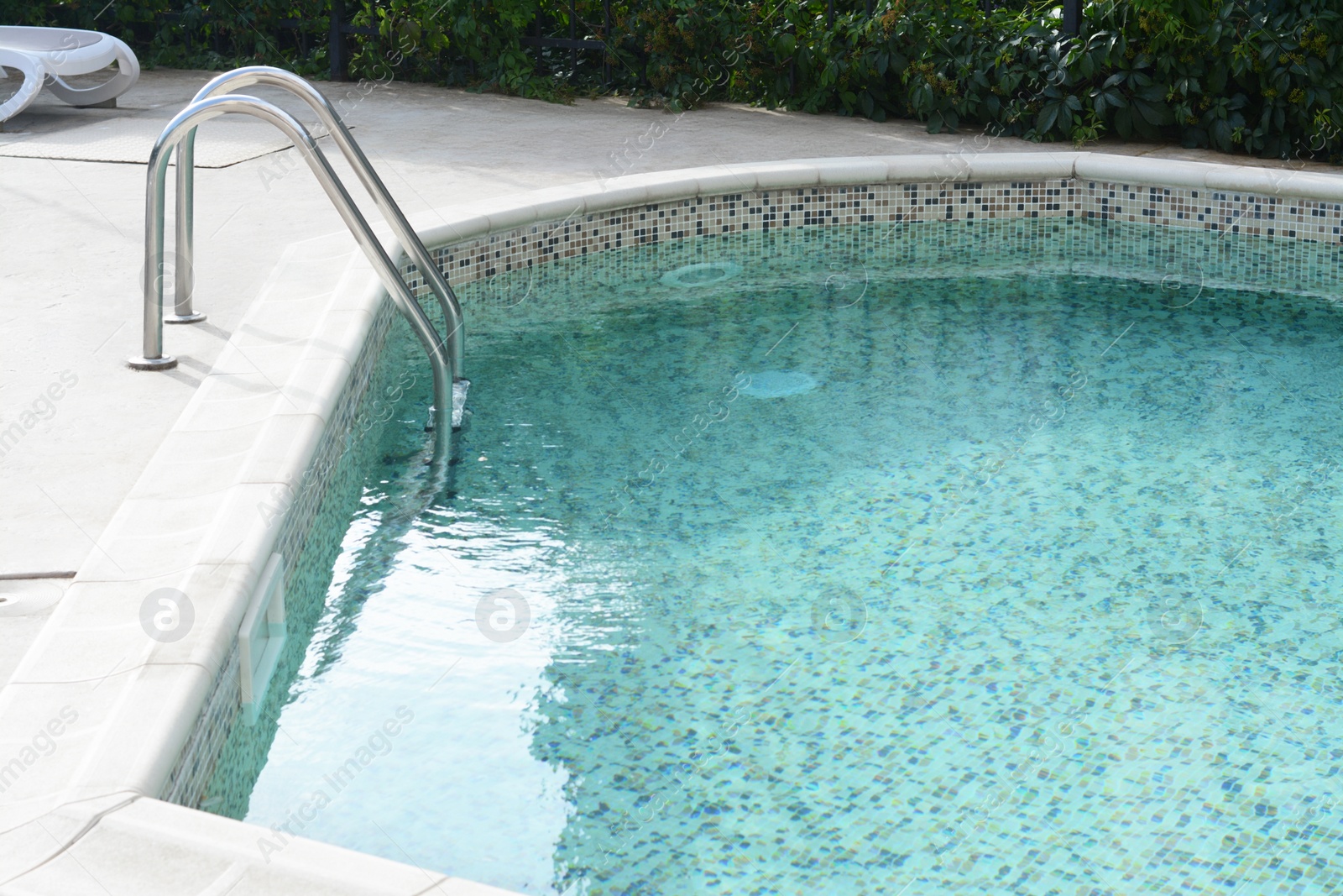 Photo of Ladder with grab bars in outdoor swimming pool