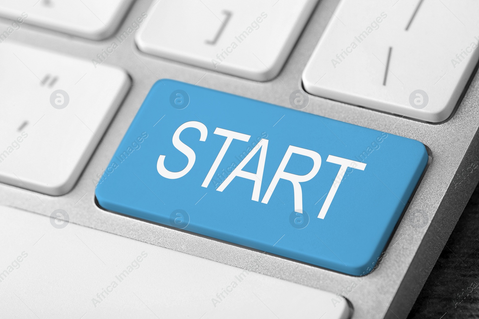 Image of Light blue button with word Start on computer keyboard, closeup