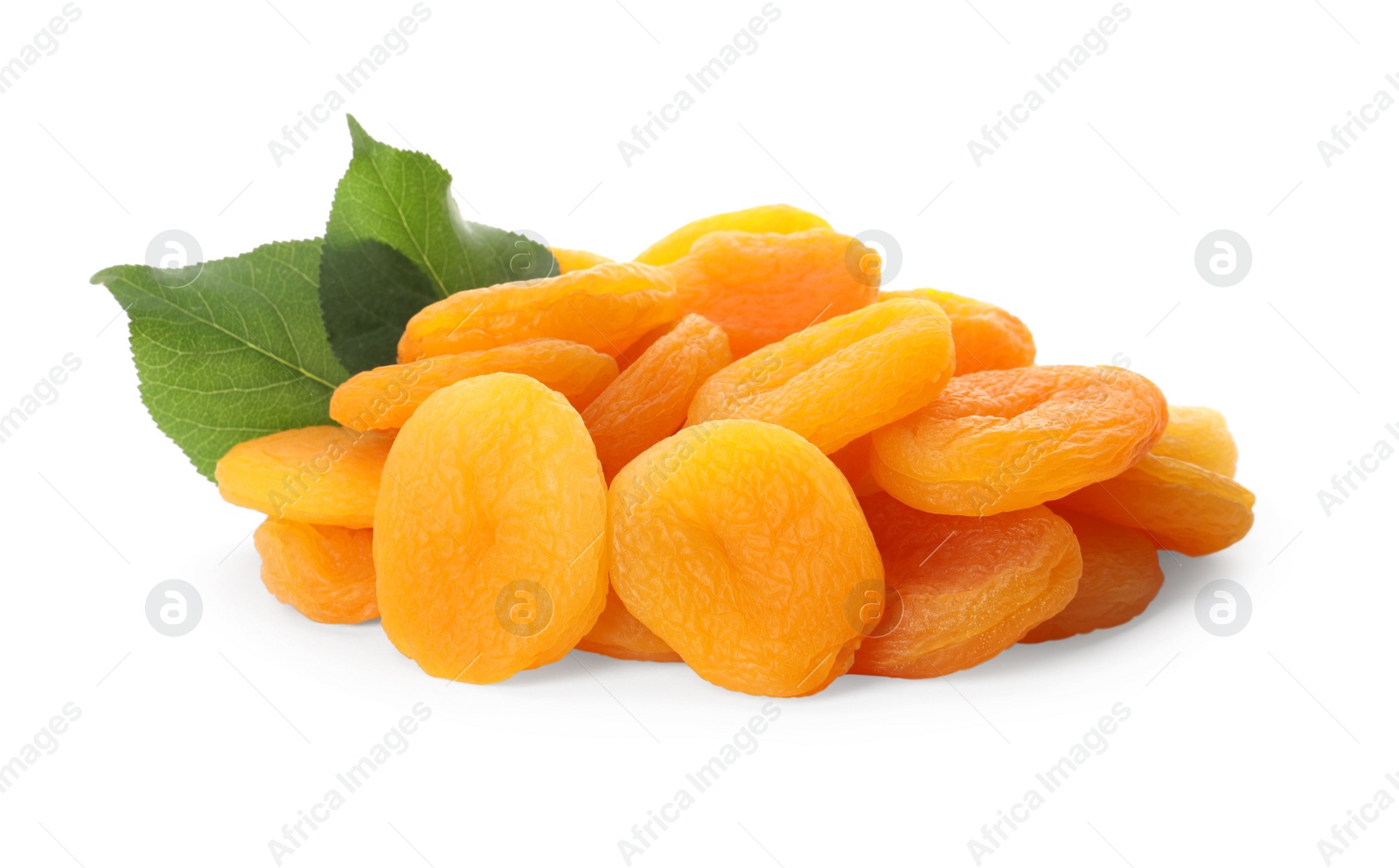 Photo of Pile of tasty apricots and green leaves on white background. Dried fruits