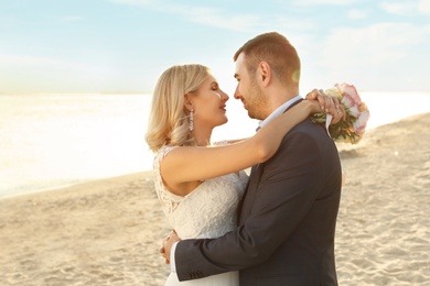 Photo of Wedding couple. Bride and groom on beach