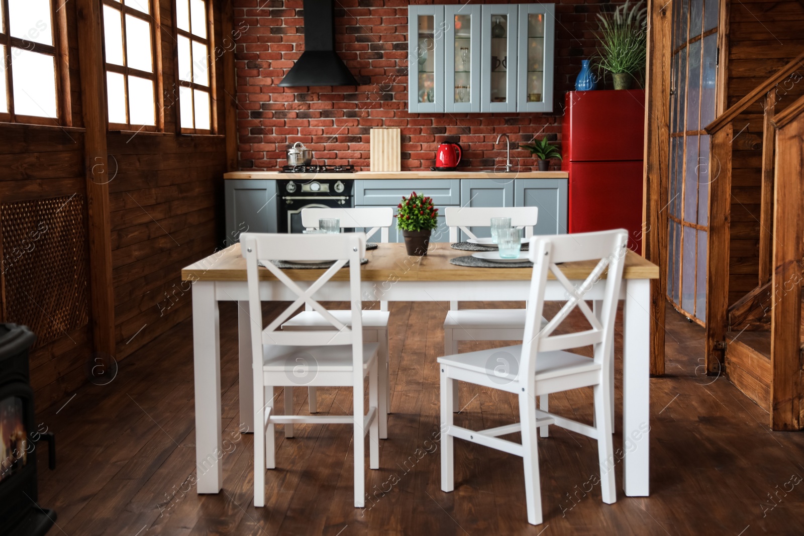 Photo of Stylish kitchen interior with dining table and chairs