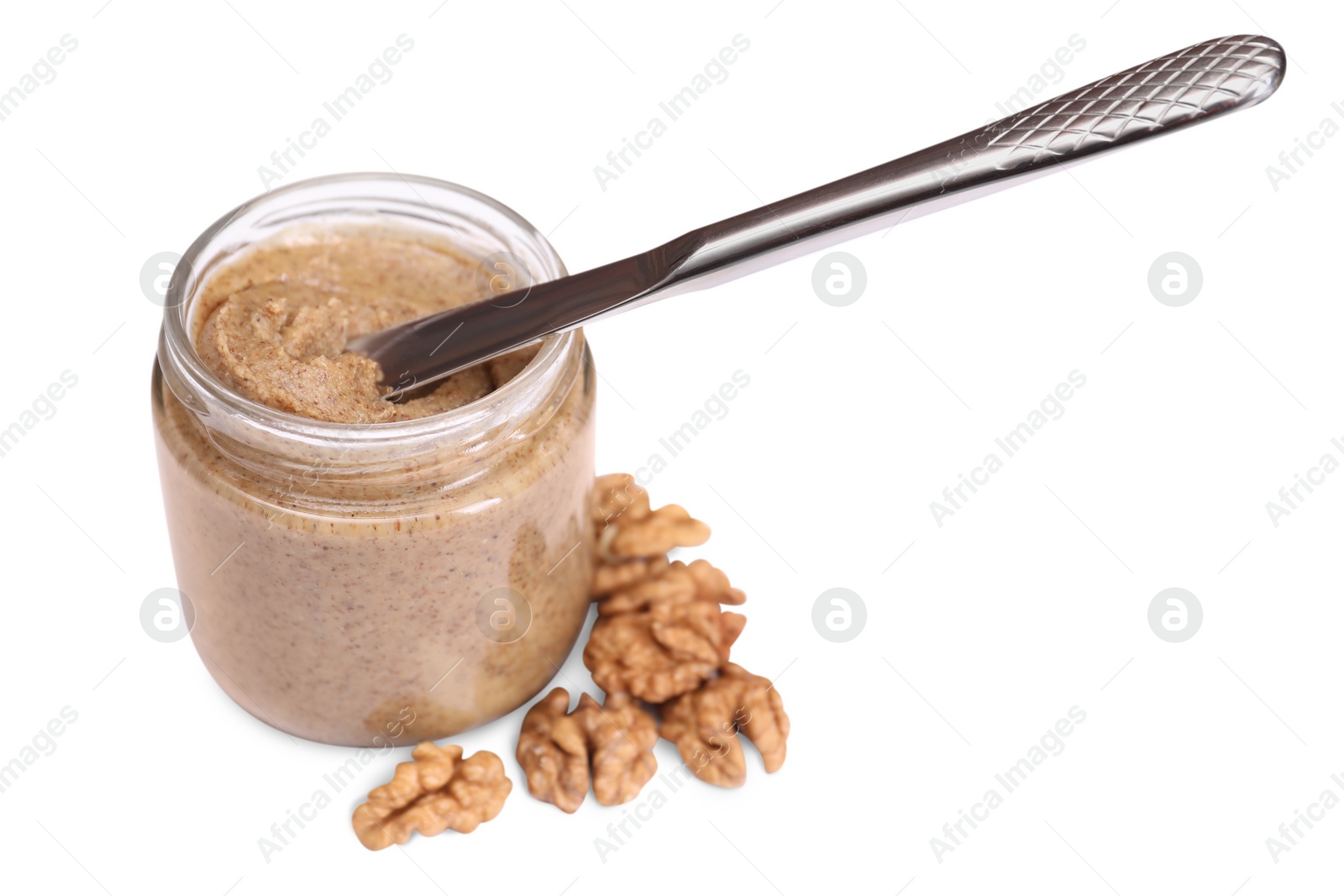 Photo of Tasty nut paste in jar, knife and walnuts isolated on white