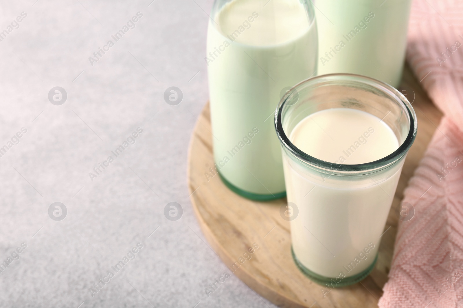 Photo of Glassware with tasty milk on table, closeup. Space for text