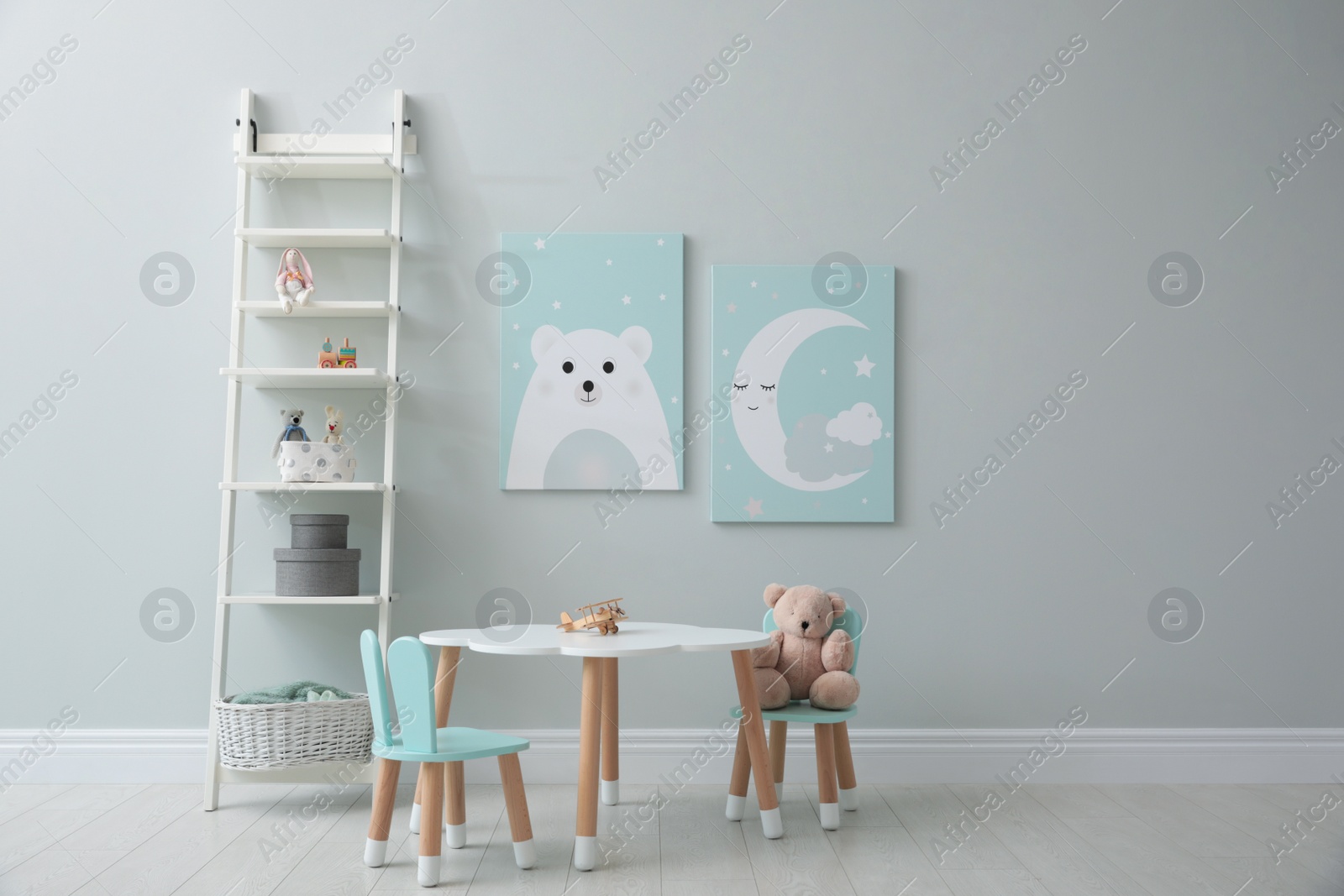 Photo of Children's room interior with table and cute pictures on wall