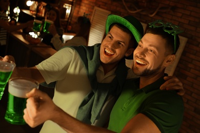 Men with beer celebrating St Patrick's day in pub