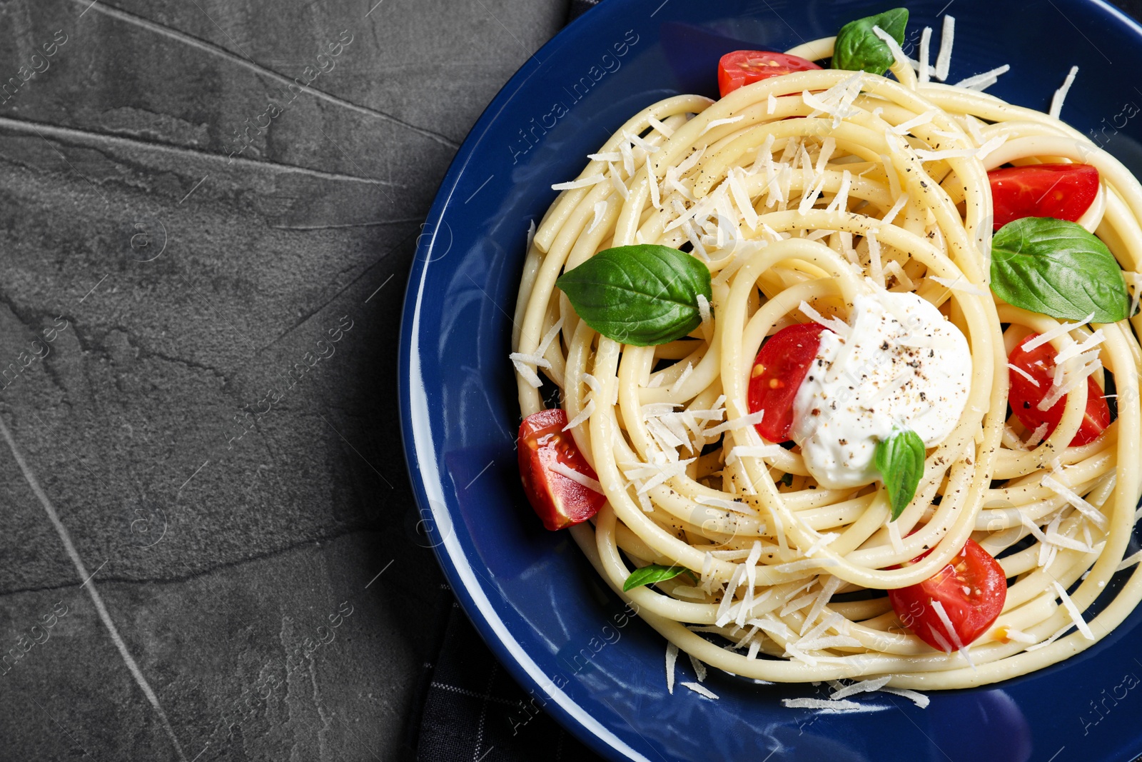 Photo of Delicious spaghetti with sour cream dressing on grey table, top view