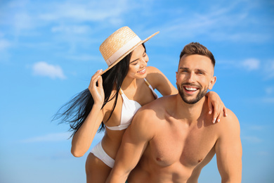 Happy young couple in beachwear on sunny day