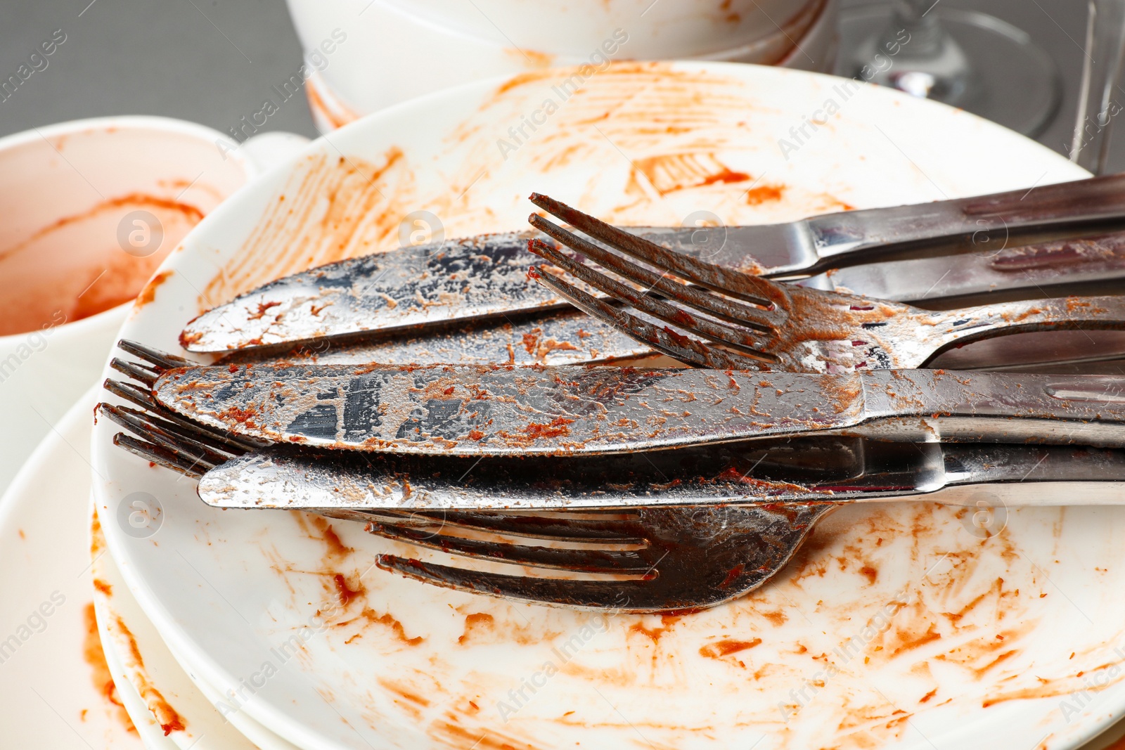 Photo of Stack of dirty dishes with cutlery, closeup