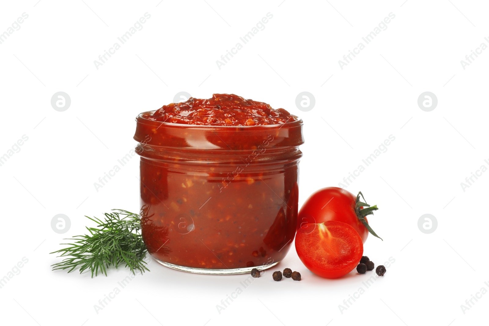 Photo of Delicious adjika sauce in glass jar and ingredients isolated on white