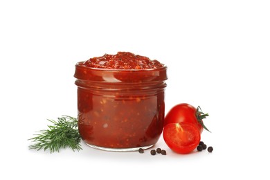 Delicious adjika sauce in glass jar and ingredients isolated on white