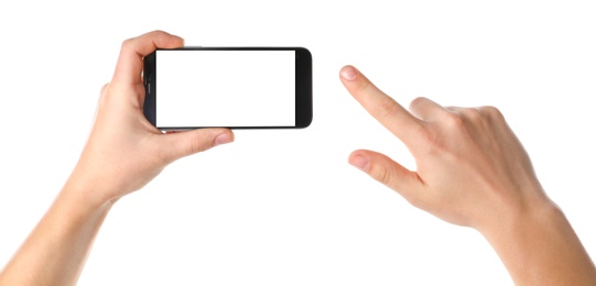 Man holding smartphone with blank screen on white background, closeup of hands. Space for text