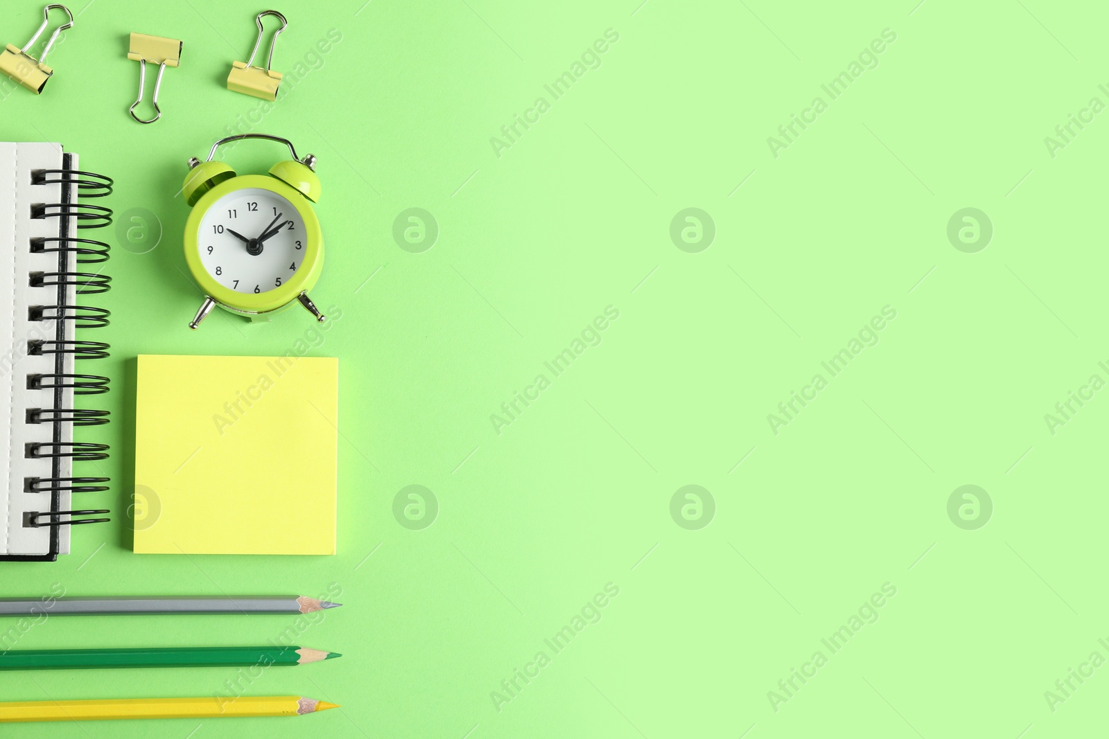 Photo of Modern office accessorises on green background, flat lay. Space for text