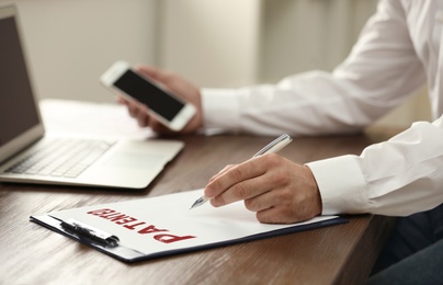 Image of Businessman working at table, closeup. Patent concept