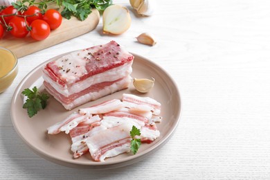 Tasty salt pork with parsley on white wooden table, space for text