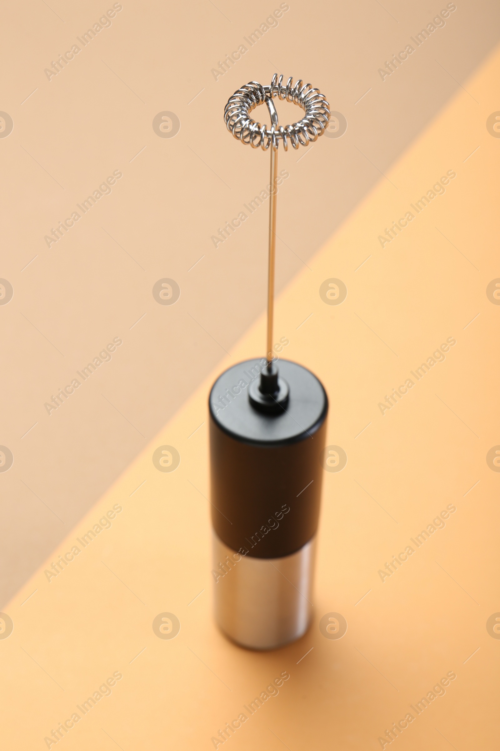 Photo of Milk frother wand on color background, above view