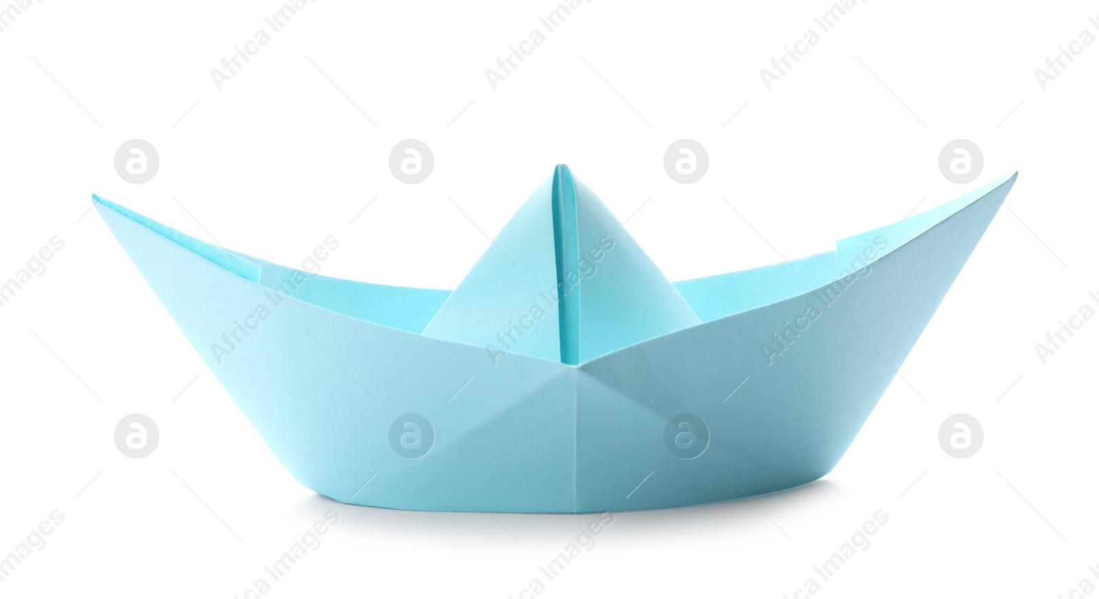 Photo of Handmade light blue paper boat isolated on white. Origami art