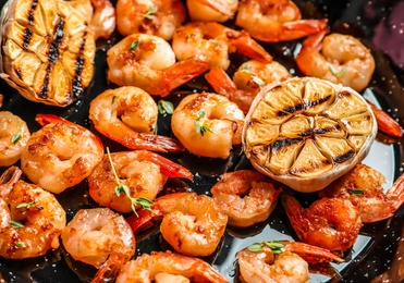 Photo of Delicious fried shrimps with garlic in frying pan, closeup