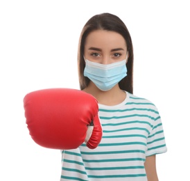 Woman with protective mask and boxing gloves on white background. Strong immunity concept