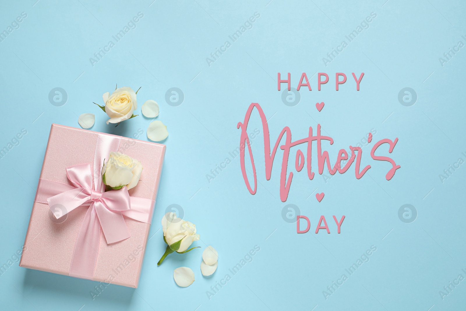 Image of Happy Mother's Day. Greeting card with gift box and beautiful flowers on light blue background, flat lay