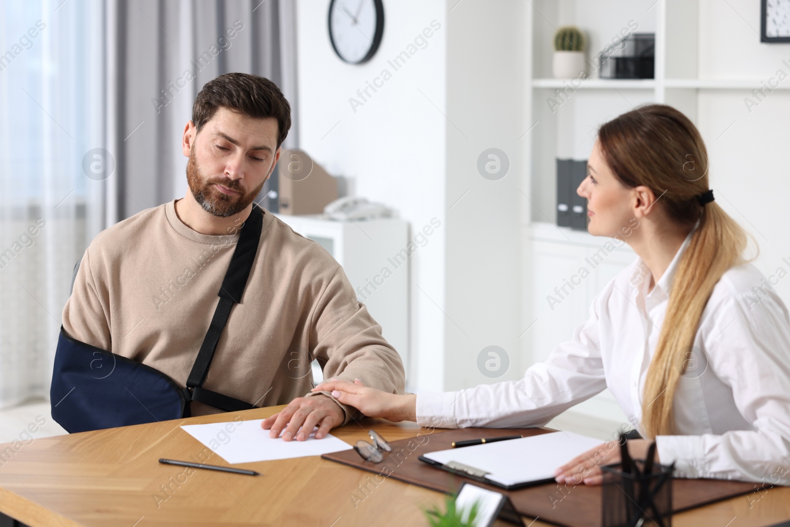 Photo of Injured woman having meeting with lawyer in office