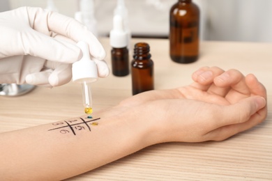 Doctor making allergy test at table, closeup