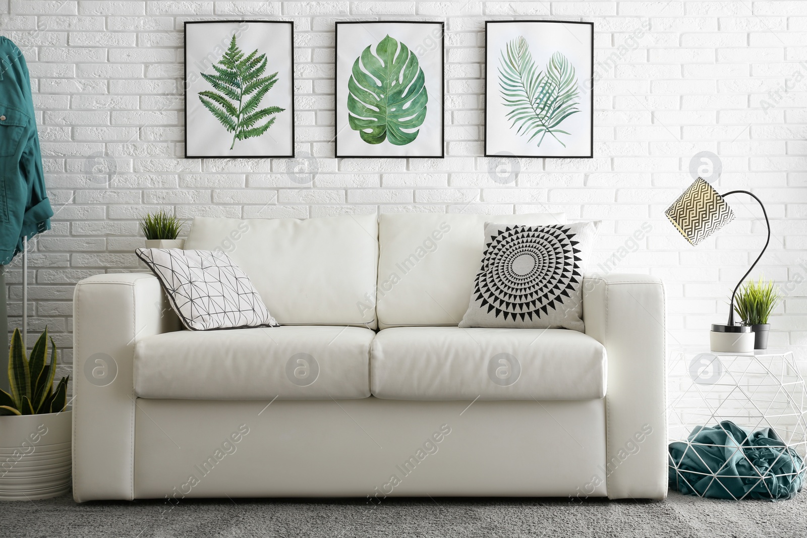 Photo of Comfortable white sofa in modern room. Interior design