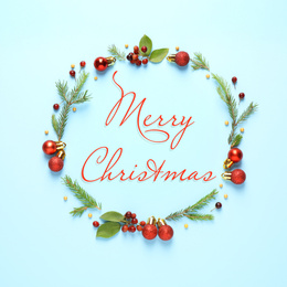 Image of Flat lay composition with text MERRY CHRISTMAS and festive decor on light blue background