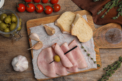 Photo of Tasty ham served on wooden table, flat lay