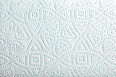Photo of Toilet paper with pattern as background, closeup
